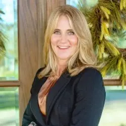 Stacy Hippler, Realtor, smiling and posing in a professional outfit, showcasing local expertise in real estate services for Central Texas.